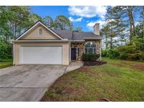 Charming single-Gathering home with a two-car garage, stone accents, and beautiful landscaping at 60 Whispering Pine Ct, Covington, GA 30016