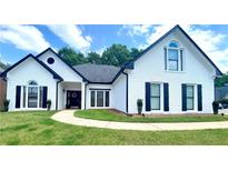 Beautiful white brick house with black trim, shutters, and a well-maintained lawn at 805 Doe Hill Ln, Roswell, GA 30075