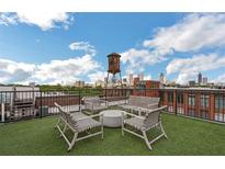 Inviting rooftop deck features seating, a water tower, and city skyline views at 170 Boulevard Se # H301, Atlanta, GA 30312