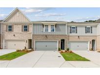 Charming townhomes featuring modern exteriors, attached garages, and manicured landscaping at 4663 Larkfield Way, Powder Springs, GA 30127