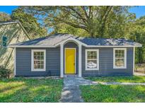 Charming exterior of the house featuring a freshly painted door and well-maintained front yard at 971 Sims Nw Ave, Atlanta, GA 30318