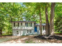Charming split-level home with freshly painted brick, new landscaping, and a bright blue front door at 271 Leafwood Ln, Riverdale, GA 30274