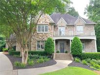 Charming two-story brick home featuring manicured landscaping, a welcoming entrance, and a beautiful stone facade at 1632 Brookhaven Close Ne, Atlanta, GA 30319