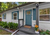 Charming front door with teal paint, brick, and landscaping at 1585 San Gabriel Ave, Decatur, GA 30032