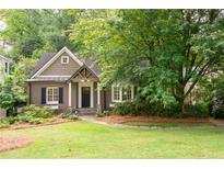 Charming home exterior featuring a well-manicured lawn, mature trees, and inviting curb appeal at 3115 Peachtree Ne Dr, Atlanta, GA 30305