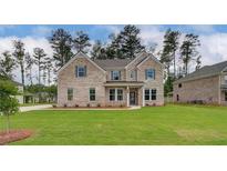 Charming two-story brick home with manicured lawn and a welcoming front entrance at 322 Delta Dr, Mcdonough, GA 30253