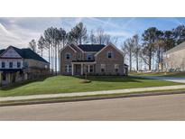 Beautiful two-story brick home with a well-manicured lawn and a classic architectural design at 322 Delta Dr, Mcdonough, GA 30253