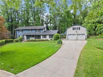 Charming two-story home with a well-manicured lawn and a large driveway leading to an oversized garage at 1190 Hess Dr, Avondale Estates, GA 30002