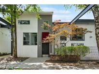 Modern two-story home with a gray and white facade, landscaped yard, and tree with orange leaves at 195 Arizona Ne Ave # 104, Atlanta, GA 30307