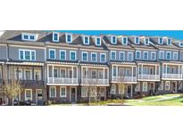 Row of gray townhomes featuring brick accents, white trim, and dormer windows at 1975 Flying Scotsman Dr # 18, Kennesaw, GA 30144
