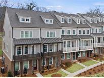 Charming townhome exteriors with neutral siding, covered porches, and well-manicured lawns showcase an inviting community at 1975 Flying Scotsman Dr # 18, Kennesaw, GA 30144