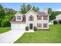 Charming two-story home with a manicured lawn and a two-car garage at 4530 Talon Way, Douglasville, GA 30135