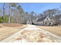 Beautiful home with a three-car garage and lovely stone driveway at 209 Wynnward Way, Sharpsburg, GA 30277