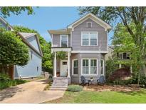 Charming two-story home with gray siding, brick accents, and a cozy front porch perfect for relaxing at 120 Candler Oaks Ln, Decatur, GA 30030