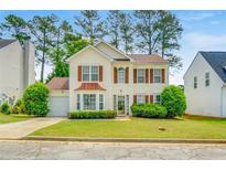 Charming two-story home with landscaped yard, inviting curb appeal, and attached garage at 3550 Willow Tree Trce, Decatur, GA 30034