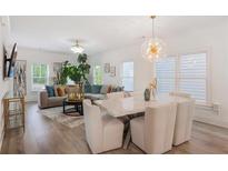Bright living room with modern decor, hardwood floors, and a stylish dining area with a marble table at 3272 Stillwood Dr, Atlanta, GA 30354
