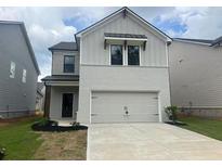 New construction featuring a two-car garage and brick and siding exterior at 4534 Eastbrook Pl, Snellville, GA 30039