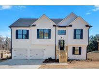 New two-story home with white siding, black shutters, and a two-car garage, enhanced by a bright blue sky at 19 Bridgemill Dr, Douglasville, GA 30134