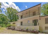 Lovely two-story home boasts an upstairs balcony overlooking the front yard and mature shade trees at 315 Renae, Marietta, GA 30060