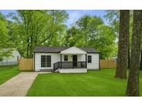 Charming single-story home with a well-manicured lawn and inviting front porch, blending classic charm with modern updates at 4103 Brenda Dr, Decatur, GA 30035