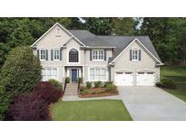 Charming two-story home features an attached two-car garage, and a beautifully landscaped yard with mature trees at 4314 Woodhaven Se Way, Smyrna, GA 30082