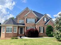 Beautiful brick two-story home with manicured lawn, dark shutters, and well-maintained landscaping at 2922 Heart Pine Way, Buford, GA 30519