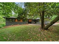 Charming home with mature trees and beautifully landscaped front yard and stone accents at 4206 Lake Laurel Se Dr, Smyrna, GA 30082