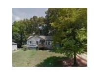Traditional single-story home with wood siding, front porch, and mature shade trees at 1369 Bluefield Sw Dr, Atlanta, GA 30310