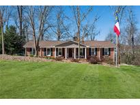 Charming brick ranch home with manicured lawn, mature trees, and welcoming front porch at 3250 North Embry Cir, Chamblee, GA 30341