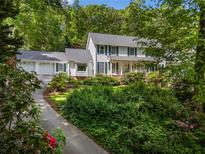 Charming two-story home with a landscaped front yard, featuring a covered porch and attached garage at 357 Breeze Hill Ln, Canton, GA 30114