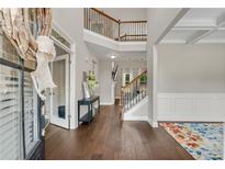 Grand two-story foyer features hardwood floors, staircase, and decorative rug, creating an inviting entrance at 4285 Hunters Walk Way, Cumming, GA 30028