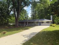 Charming single-story home with a brick facade, mature trees, and a long driveway at 2463 Briarmoor Ne Rd, Atlanta, GA 30345