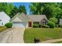 Charming single-story home with manicured lawn, attached garage, and inviting curb appeal at 648 Bellingham Dr, Sugar Hill, GA 30518