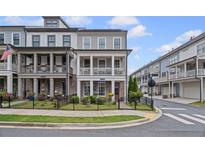 Charming two-story home featuring a welcoming front porch, brick facade, and well-manicured lawn at 214 Bluestone Dr, Woodstock, GA 30188