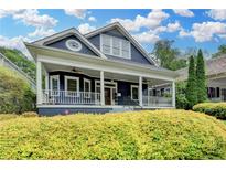 Charming two-story home with a welcoming front porch and manicured landscaping at 799 Monroe Ne Dr, Atlanta, GA 30308