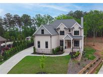 Charming two-story brick home featuring a landscaped yard and a spacious driveway at 1525 Tapestry Rdg, Lawrenceville, GA 30045