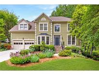 Charming two-story home with a well-manicured lawn, stone stairs, and beautifully landscaped front yard at 10540 Waters Ridge Dr, Alpharetta, GA 30022