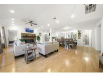 Open-concept living space with fireplace, hardwood floors, and modern furnishings at 2710 Hedgewood Nw Dr, Atlanta, GA 30311
