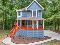 Charming two-story home with a covered porch and eye-catching curb appeal, nestled in a serene wooded setting at 1310 Ridgeview Rd, Auburn, GA 30011