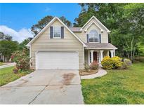 Charming two-story home features a two-car garage and beautiful landscaping at 2320 Crystal Ct, Loganville, GA 30052