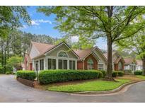 Charming single-story home featuring brick accents, manicured landscaping, and a welcoming entrance at 3746 Vineyards Lake Nw Cir # U6, Kennesaw, GA 30144