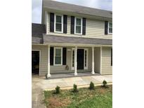 Charming two-story home with a welcoming front porch and classic black shutters at 985 Romer Pl, Stone Mountain, GA 30083