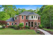 Beautiful brick two-story home featuring a landscaped yard and inviting arched entryway at 8032 Banks Mill Rd, Douglasville, GA 30135