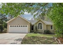Charming single-story home with a two-car garage and well-maintained lawn at 2410 Bankstone Sw Dr, Marietta, GA 30064