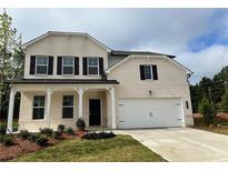 Charming two-story brick home features a two-car garage, covered front porch, and manicured lawn at 3311 Burkston Pl, Buford, GA 30519