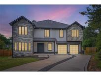 Stunning two-story home features stone accents, a two-car garage, and a landscaped front yard at 2740 Drew Valley Ne Rd, Brookhaven, GA 30319