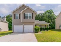 Charming two-story home with a two car garage and well-maintained lawn at 4870 Heather Mill Trce, Snellville, GA 30039