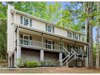 Charming two-story home with a covered front porch and well-maintained landscaping at 1627 Rex Dr, Marietta, GA 30066