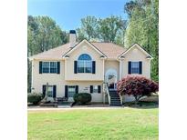 Charming two-story home features a landscaped front yard with a quaint patio seating area at 3809 Autumn View Nw Ln, Acworth, GA 30101