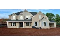 A stately two-story home featuring a brick facade, grey accents, and a charming covered front porch at 4015 Sierra Vista Cir, Cumming, GA 30040
